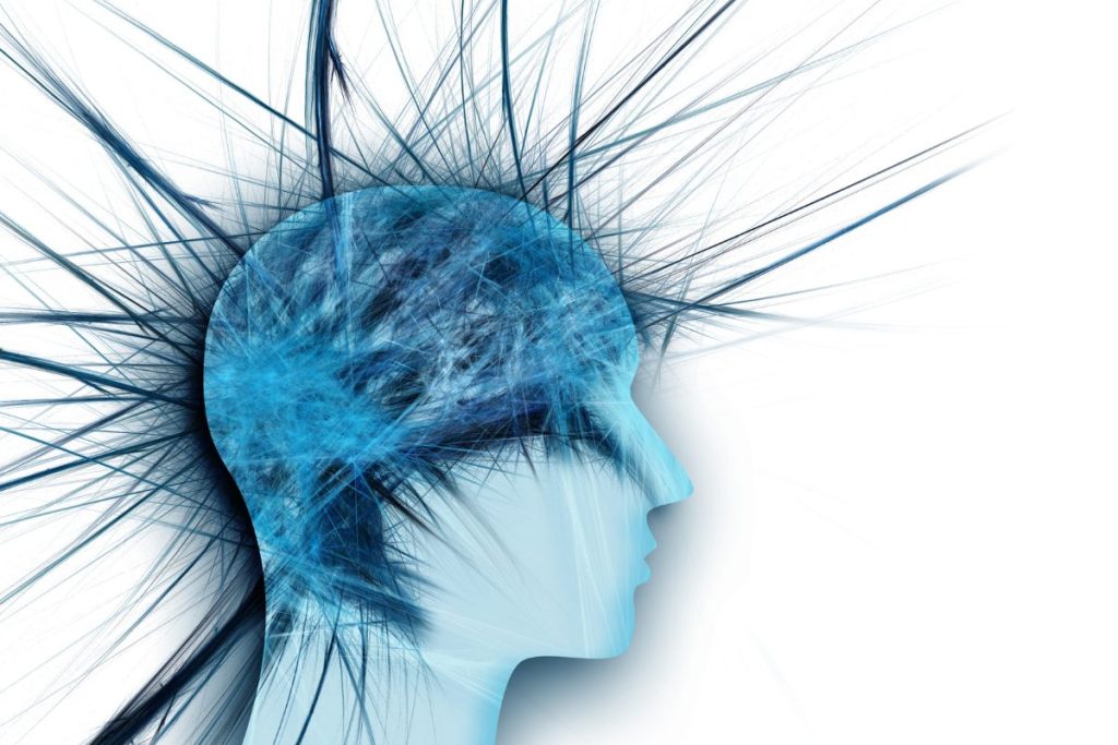 Pins and needles coming out of the silhouette of a head. Portraying headaches, migraines, brain fog, fatigue.