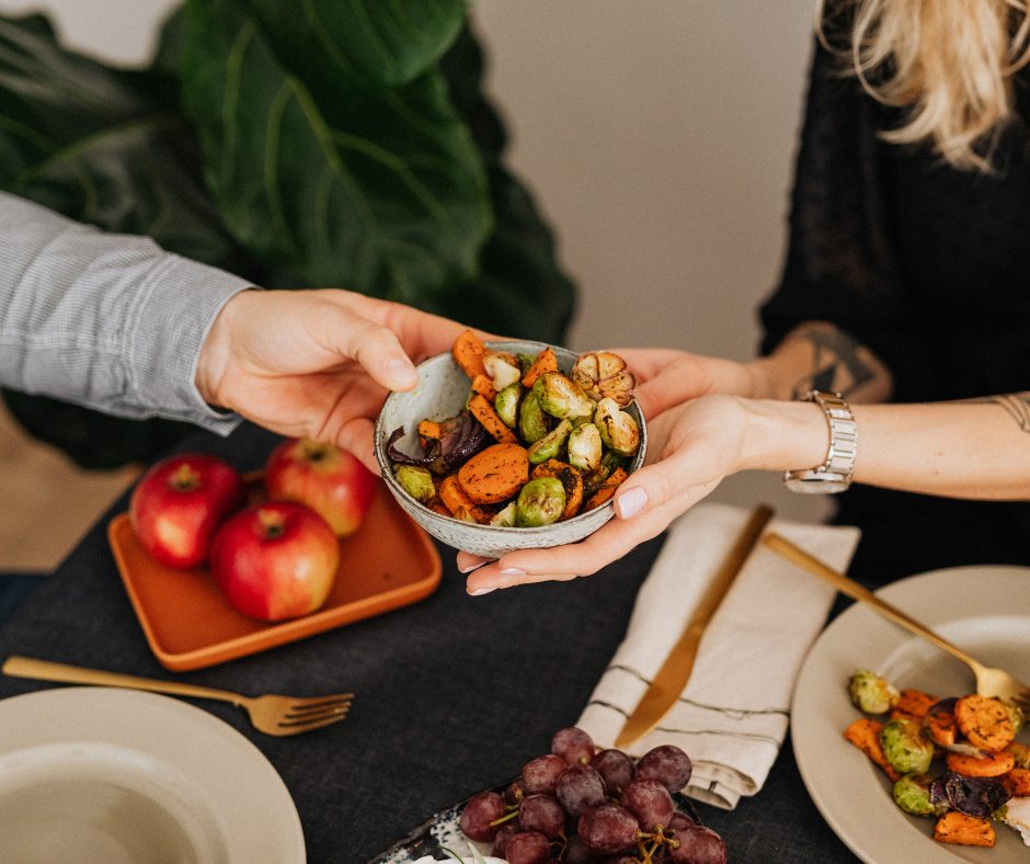 Passing healthy festive dishes around the table. 